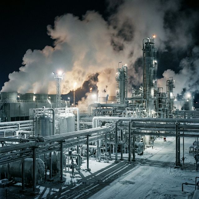 Refinery under thermal stress during winter freeze — frost on pipes, massive steam clouds