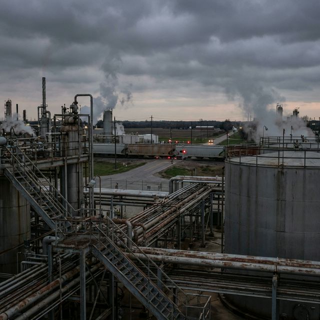 Refinery complex with rail crossing visible in distance — emergency response blocked